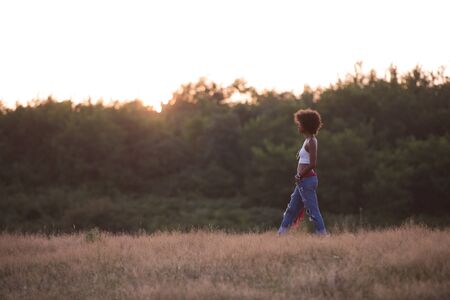 Healthy Looking Smiling Young African American Female beautiful summer evening in natureの写真素材