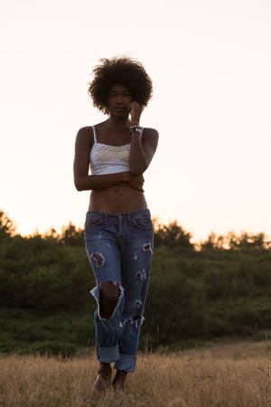 Healthy Looking Smiling Young African American Female beautiful summer evening in natureの写真素材