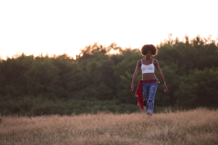 Healthy Looking Smiling Young African American Female beautiful summer evening in natureの写真素材