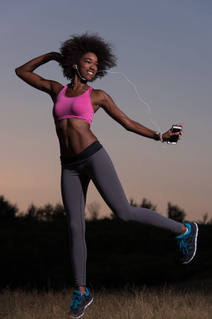 Young healthy black woman is doing stretching exercise relaxing and warm up after jogging and...