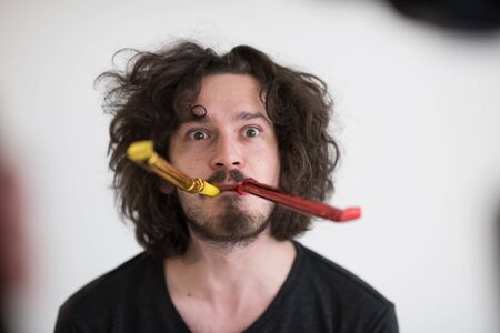 young man on party celebrating new year and dancingの写真素材