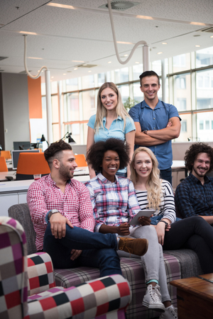 Multiethnic startup business team on meeting in modern bright office interior brainstorming, working on laptop and tablet computerの写真素材