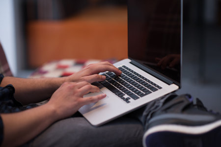 technology, home and lifestyle concept  of man working with laptop computer and sitting on sofaa