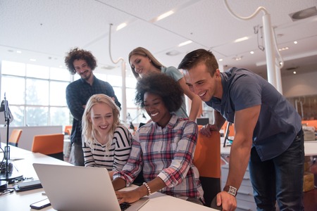 Multiethnic startup business team on meeting in modern bright office interior brainstorming, working on laptopの写真素材