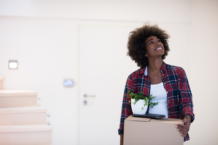 Beautiful African  American girl moving in the new apartmentの写真素材