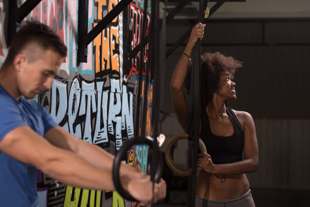 dip ring young man and african american woman relaxed after workout at gym dipping exercise
