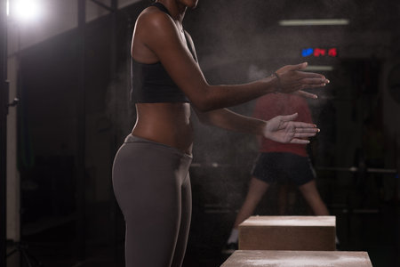 Gym Chalk Magnesium Carbonate hands clapping young african american woman for climbing workout