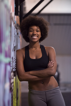 portrait of a young beautiful African American women in sports clothes after a workout at the gymの写真素材