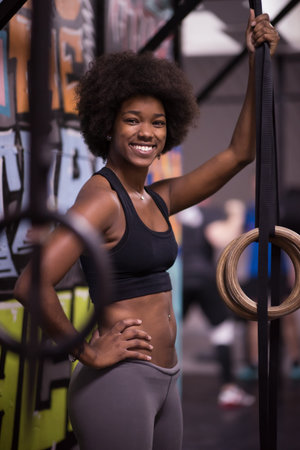 Fitness dip ring african american young woman relaxed after workout at gym dipping exerciseの写真素材