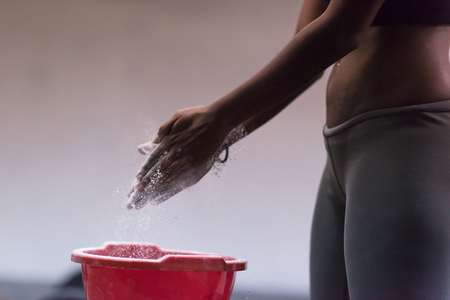 Gym Chalk Magnesium Carbonate hands clapping young african american woman for climbing workoutの写真素材