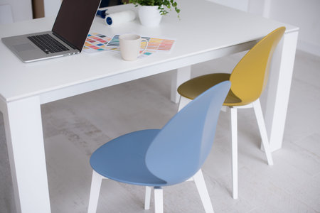 laptop on a white kitchen tableの写真素材