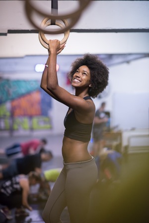 Fitness dip ring beautiful young african american woman workout at gym dipping exerciseの写真素材