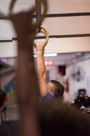 Cropped shot of male hands on gymnastics rings