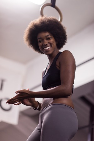 Fitness dip ring beautiful young african american woman workout at gym dipping exerciseの写真素材