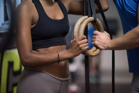 dip ring young man and african american woman relaxed after workout at gym dipping exerciseの写真素材