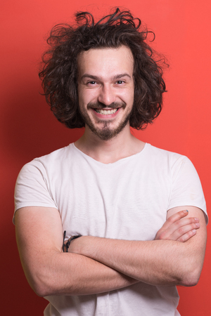 Portrait of a beautiful  young man with funny hair over color background with copyspace expressing different emotionsの写真素材