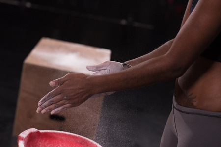 Gym Chalk Magnesium Carbonate hands clapping young african american woman for climbing workoutの写真素材