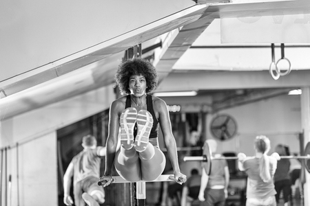 african american athlete woman workout out arms on dips horizontal parallel bars Exercise training triceps and biceps doing push upsの写真素材