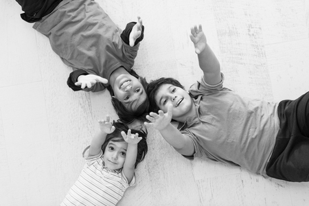 happy young boys having fun on the floor in a new modern homeの写真素材