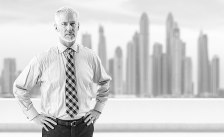 Portrait of senior businessman in front of the big cityの写真素材