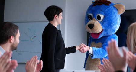 Boss dresed as teddy bear having fun with bussines people in modern corporate office