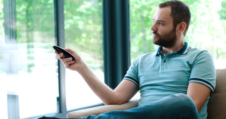 man watching tv at modern villa