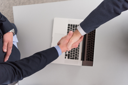 Business Partner Shake Hands on meetinig in modern office building top viewの写真素材
