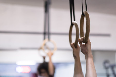 Cropped shot of male hands on gymnastics rings