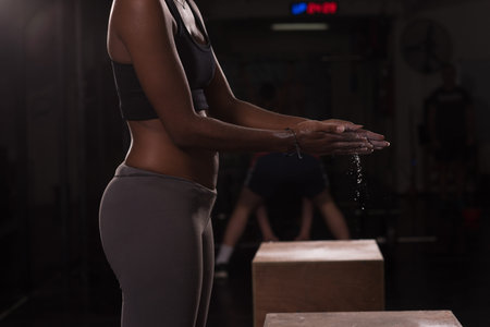 Gym Chalk Magnesium Carbonate hands clapping young african american woman for climbing workout