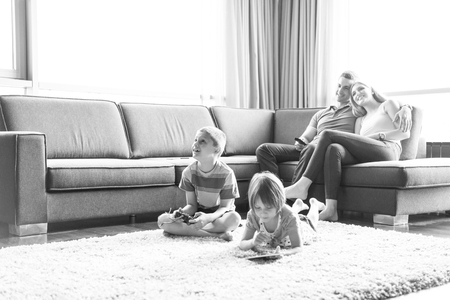 Happy Young Family Playing Together at homeの写真素材