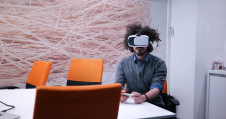 happy man getting experience using VR-headset glasses of virtual reality at home