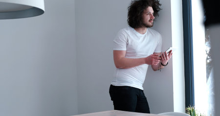 Handsome casual young man using a tablet at luxurious home