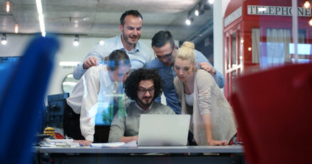 Group of a young business people discussing business plan at modern startup office building
