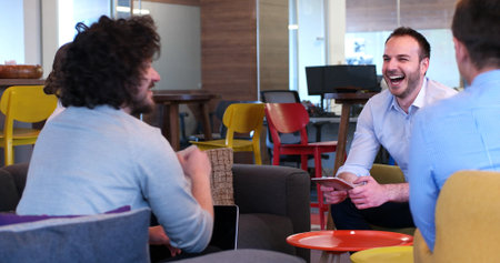 Group of a young business people discussing business plan at modern startup office building
