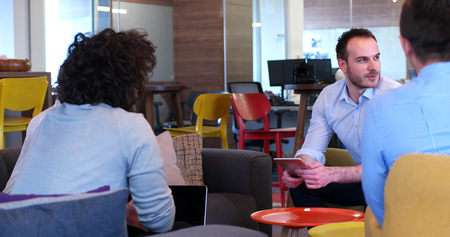 Group of a young business people discussing business plan at modern startup office buildingの写真素材