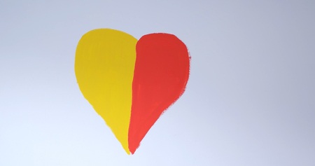 red and yellow heart on a white wallの写真素材