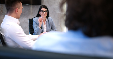 Group of a young business people discussing business plan at modern startup office buildingの写真素材