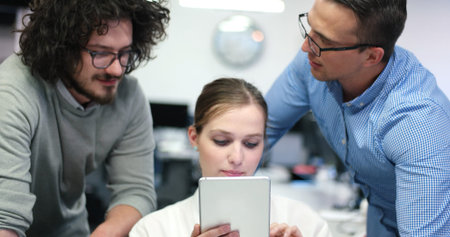 Group of a young business people discussing business plan at modern startup office buildingの写真素材