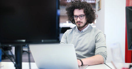 Young Entrepreneur Freelancer Working Using A Laptop In Coworking space