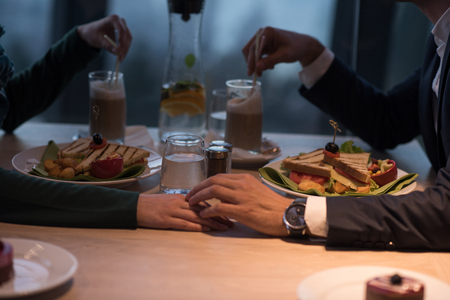 Couple celebrate Valentine's day with romantic dinner in restaurant near the windowの写真素材