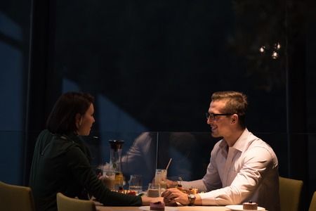 Couple celebrate Valentine's day with romantic dinner in restaurant near the windowの写真素材