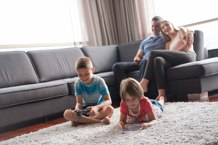 Happy Young Family Playing Together at homeの写真素材