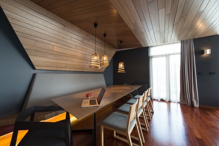 Notebook with blank screen on table in luxury living room.の写真素材