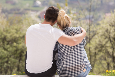 young beautiful handsome couple enjoying morning coffee in front of their luxury home villaの写真素材
