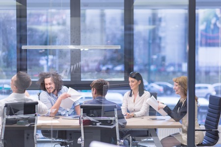 Group of a young business people discussing business plan at modern startup office buildingの写真素材