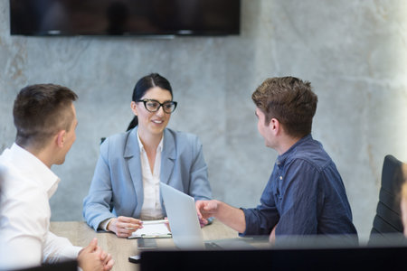 Group of a young business people discussing business plan at modern startup office buildingの写真素材