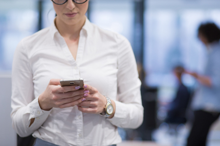 female manager using cell telephone in startup office interiorの写真素材
