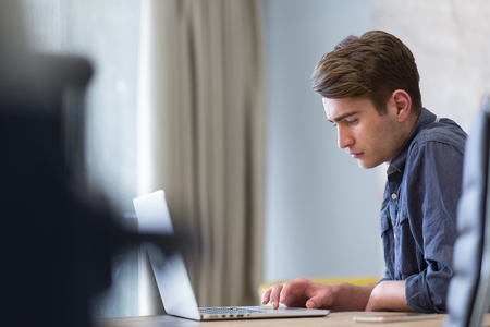 Young Entrepreneur Freelancer Working Using A Laptop In Coworking spaceの写真素材