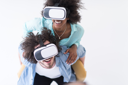Happy multiethnic couple getting experience using VR headset glasses of virtual reality, isolated on white backgroundの写真素材