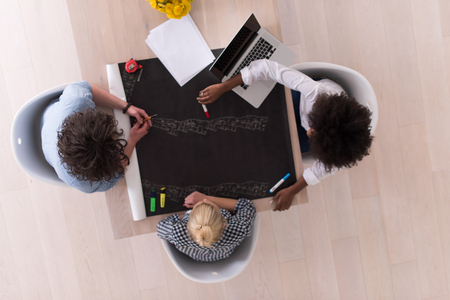 Multiethnic startup business team on meeting in modern bright office interior brainstorming, top viewの写真素材